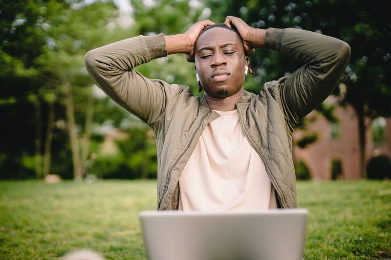 man sitting on grass